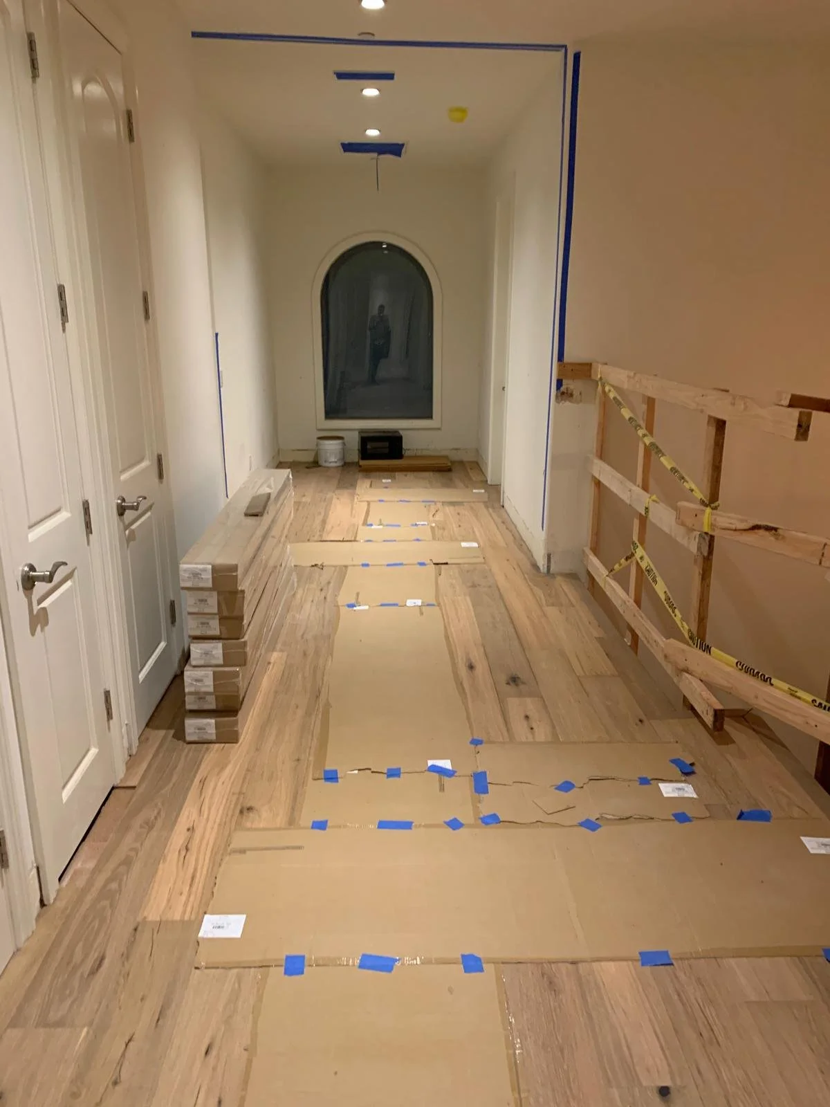 Interior hallway of Brentwood custom home during construction with flooring installation and finish work in progress