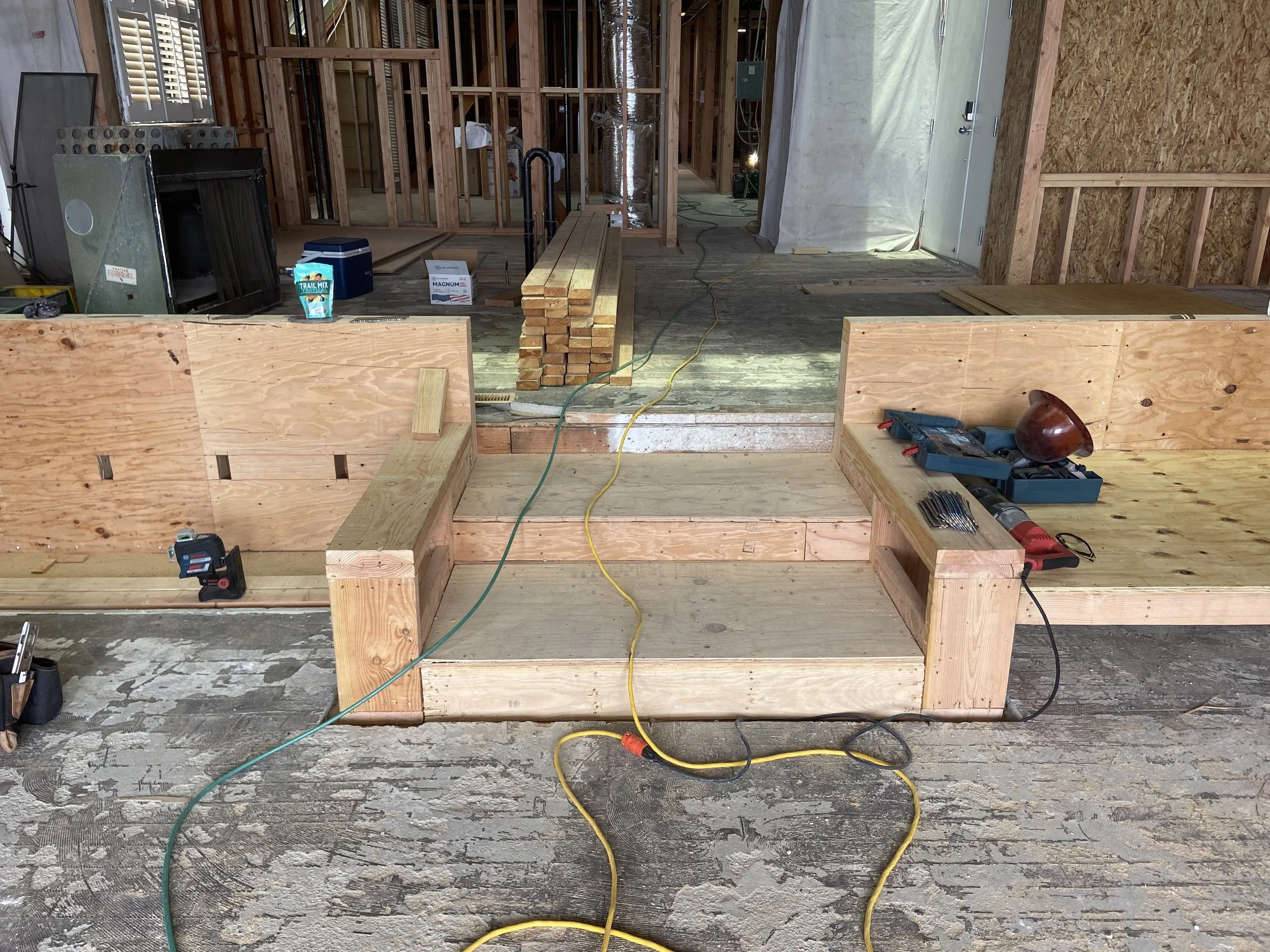 Malibu condo renovation in progress with new framing, platform construction, and layout reconfiguration during rebuild phase