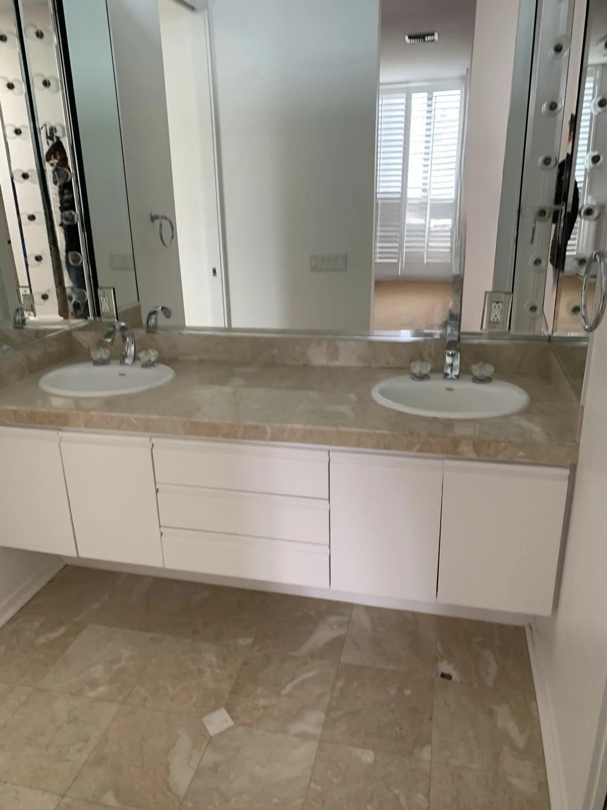 Malibu condo bathroom before remodel with outdated double vanity, beige countertop, and original finishes prior to full renovation
