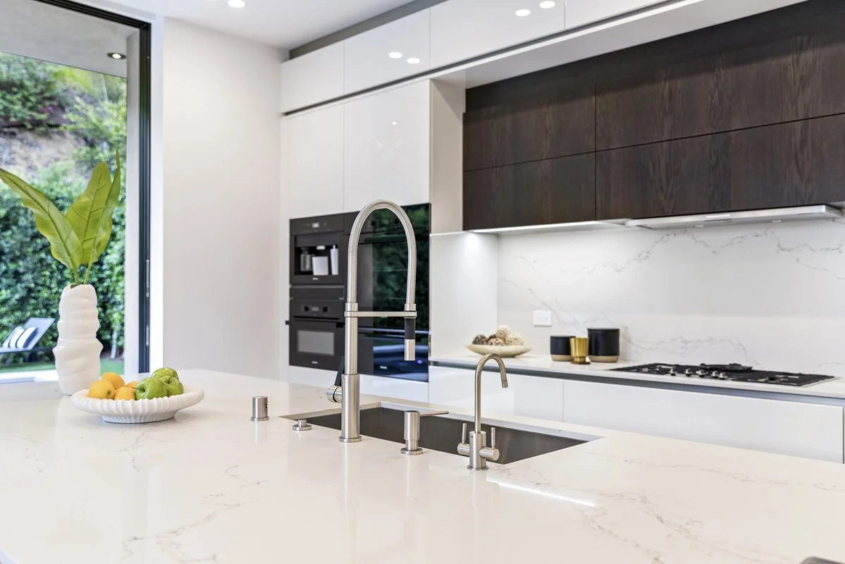 Beverly Hills kitchen detail with quartz countertops, gas cooktop, and integrated wall ovens