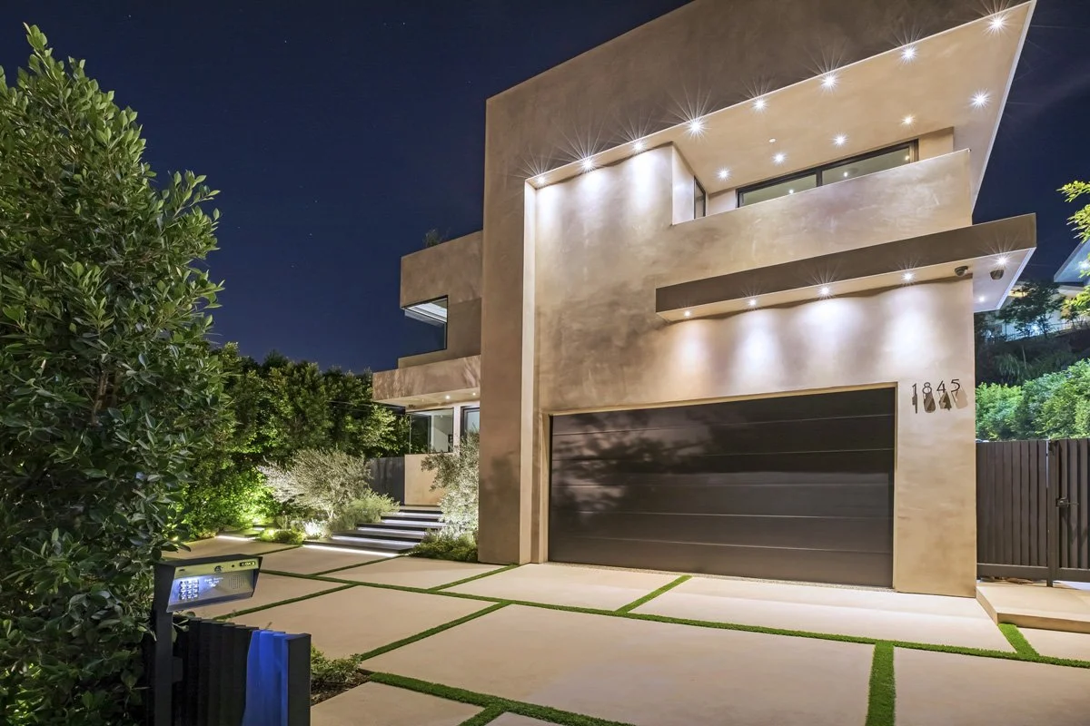 Beverly Hills contemporary front elevation at dusk with smooth plaster façade and landscape lighting