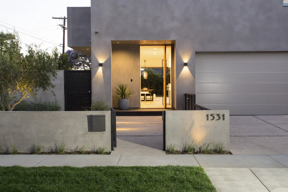 Modern Venice home exterior with illuminated entry and minimalist architectural design