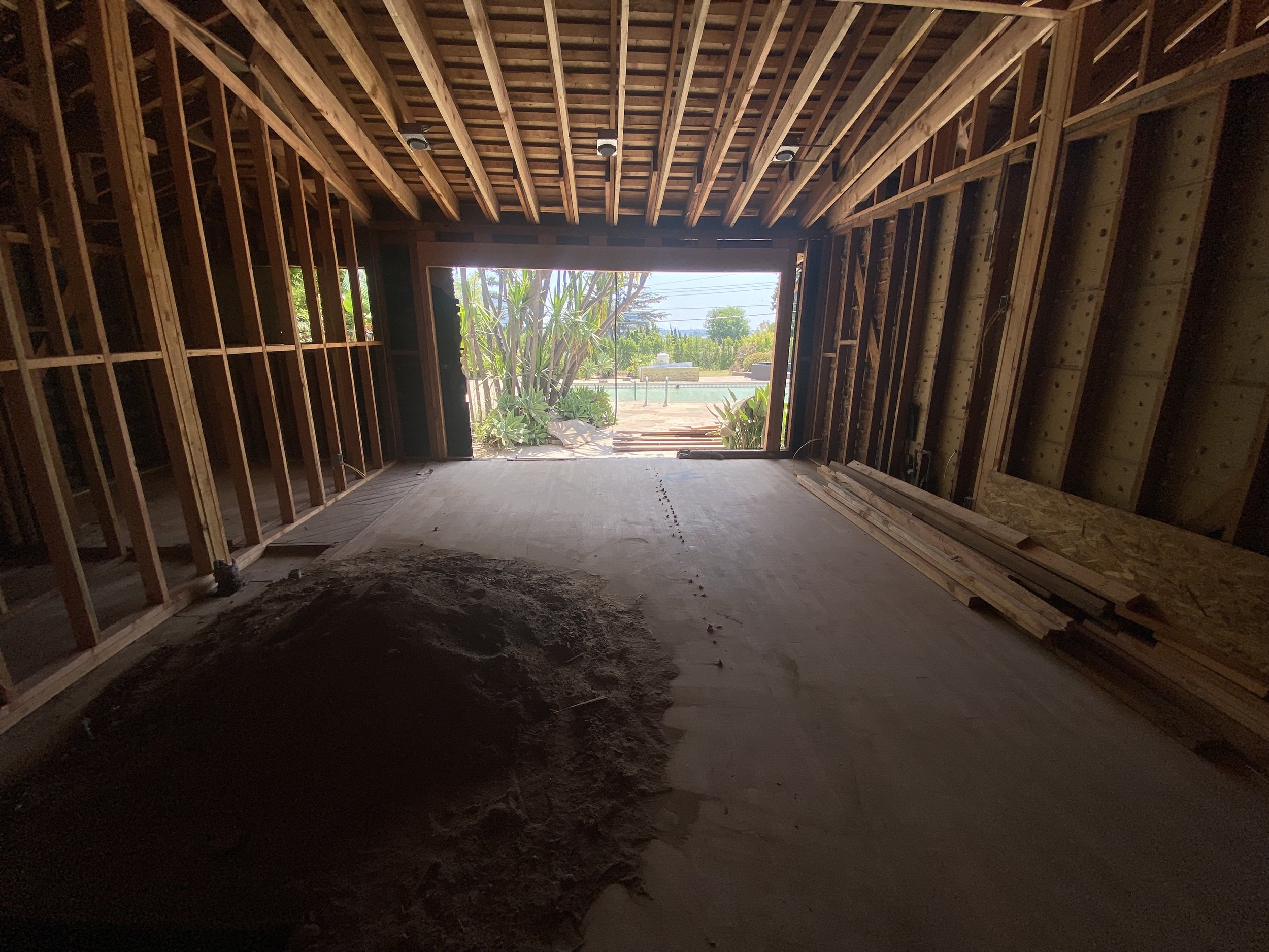 Culver City remodel in progress with exposed framing and garage opening prepared for ADU conversion and new layout integration