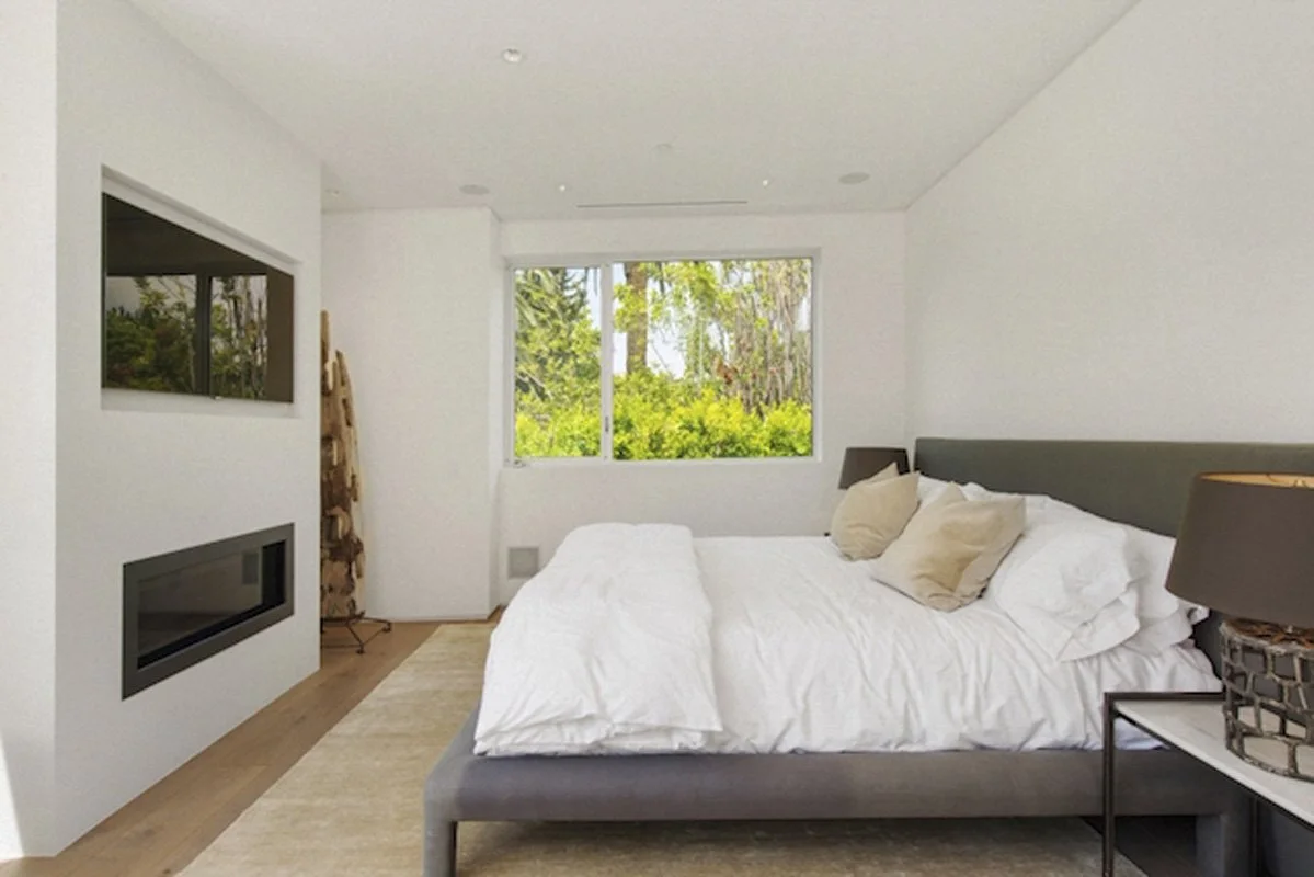 Bright primary bedroom in West Hollywood custom home with large windows and natural light.