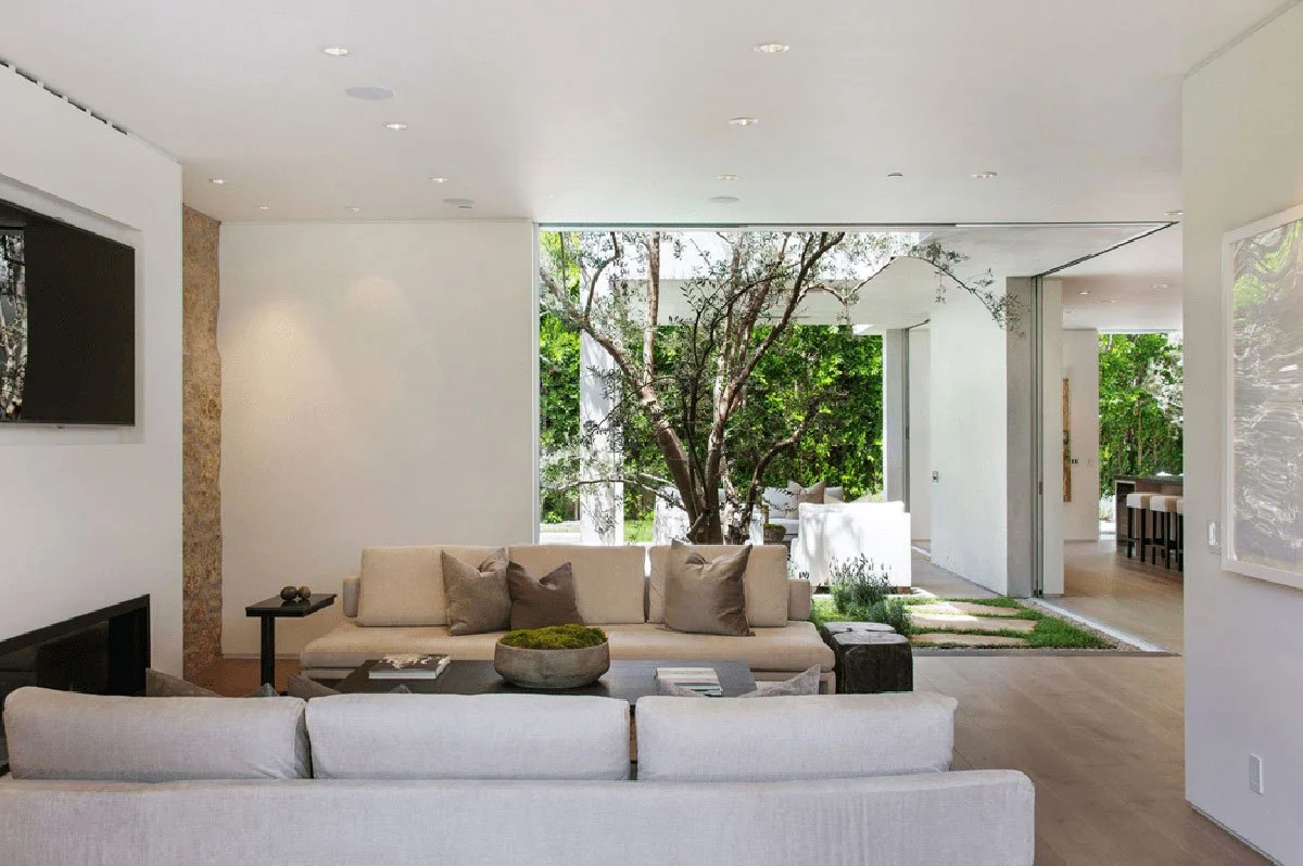 Indoor–outdoor courtyard view connecting living room and kitchen in West Hollywood modern home.