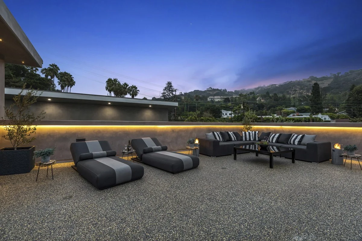 Beverly Hills rooftop terrace at sunset with chaise lounges, sectional seating, and integrated LED lighting