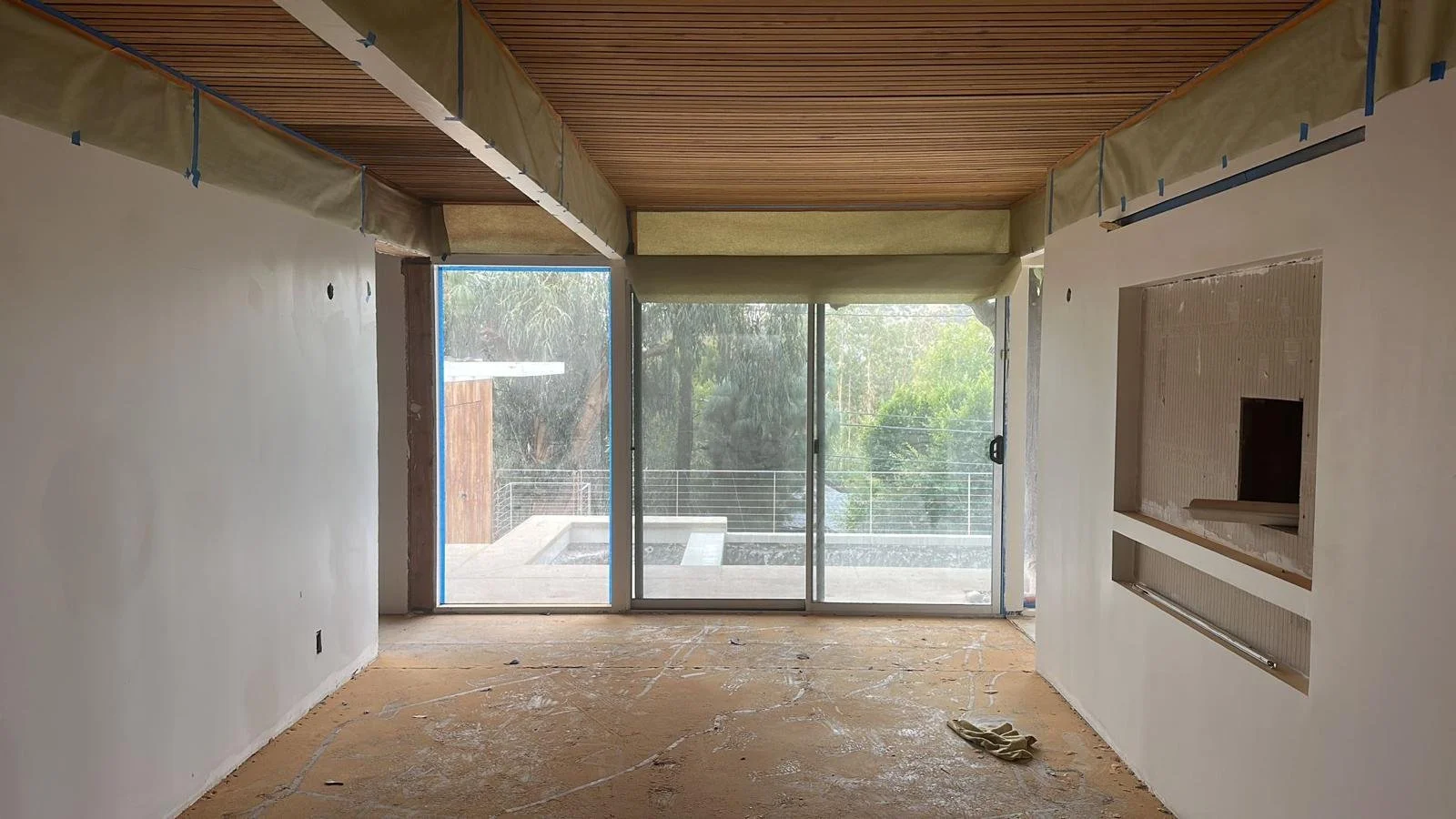 Hollywood Hills mid-century home in progress with open floor plan, exposed beams, and layout prepared for kitchen and living integration