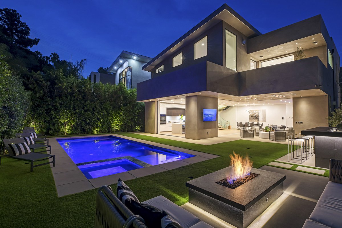 Beverly Hills backyard fire feature with modern seating, illuminated spa, and architectural overhangs