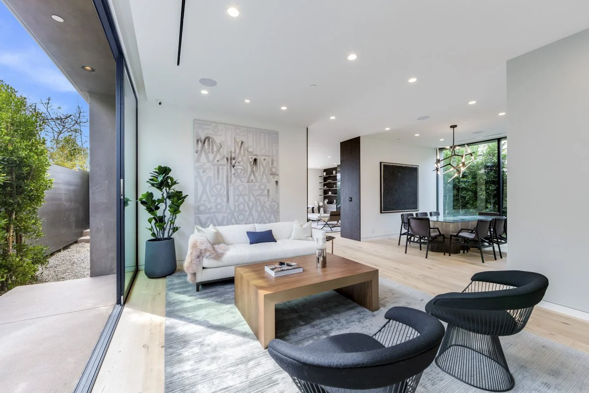 West Hollywood custom home living area with floor-to-ceiling glass, open dining space, and minimalist interior design