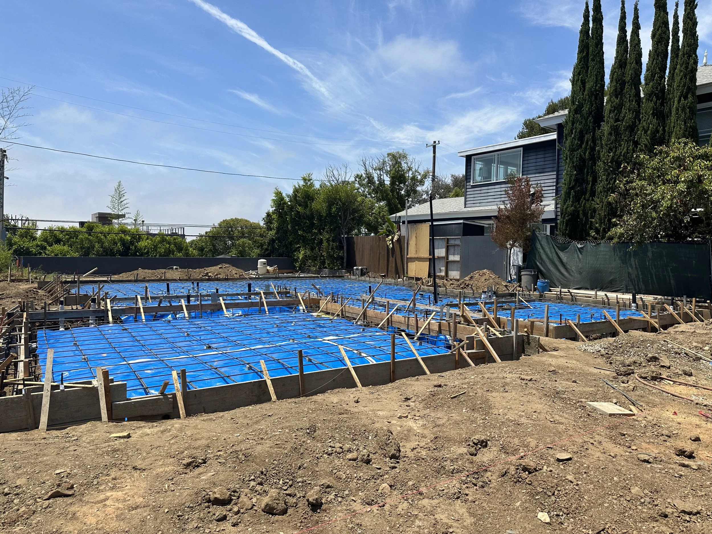 Foundation preparation with formwork, rebar, and slab layout for new custom home construction