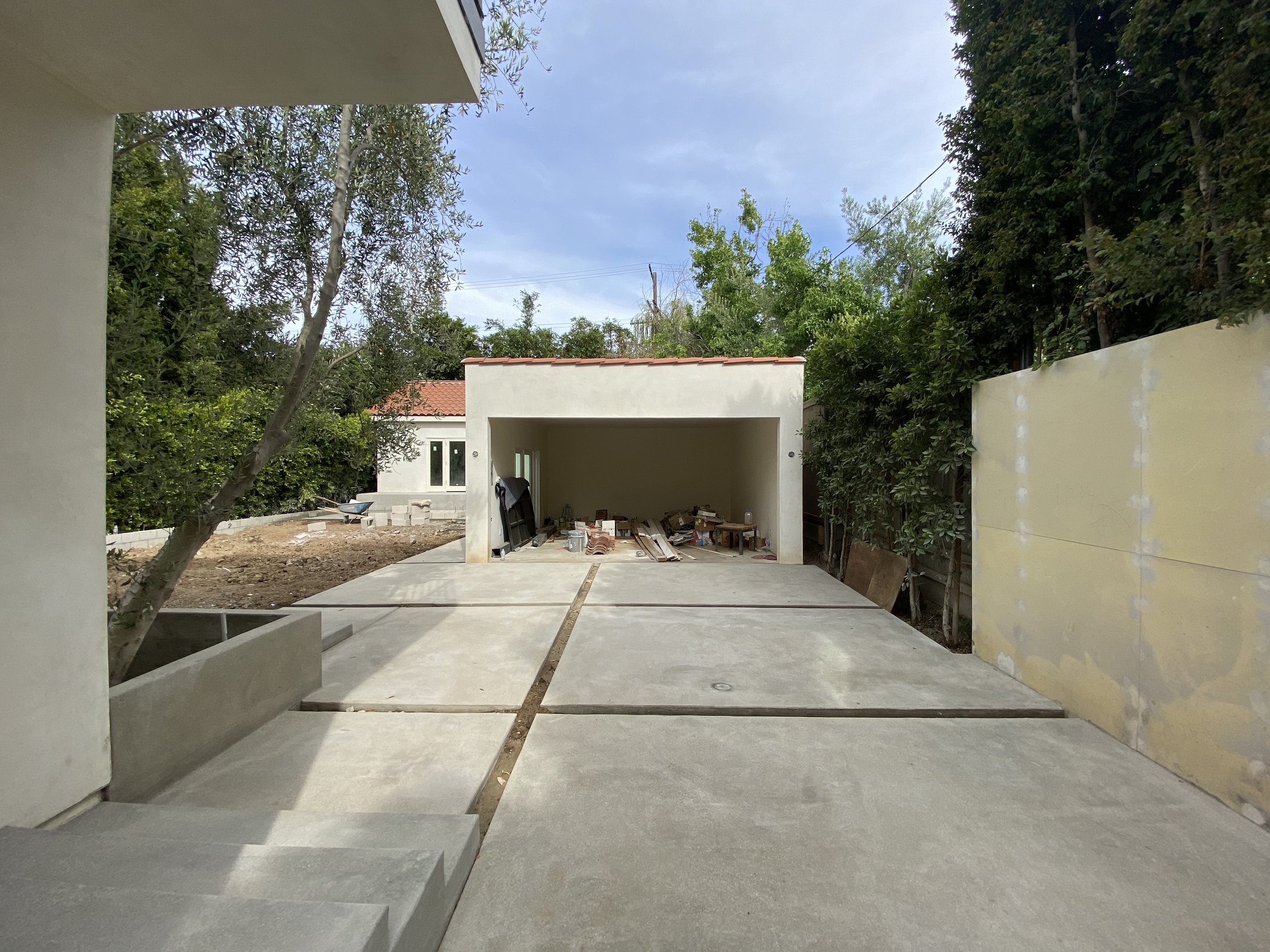 Hancock Park property during construction with new garage and ADU structure taking shape and site work in progress