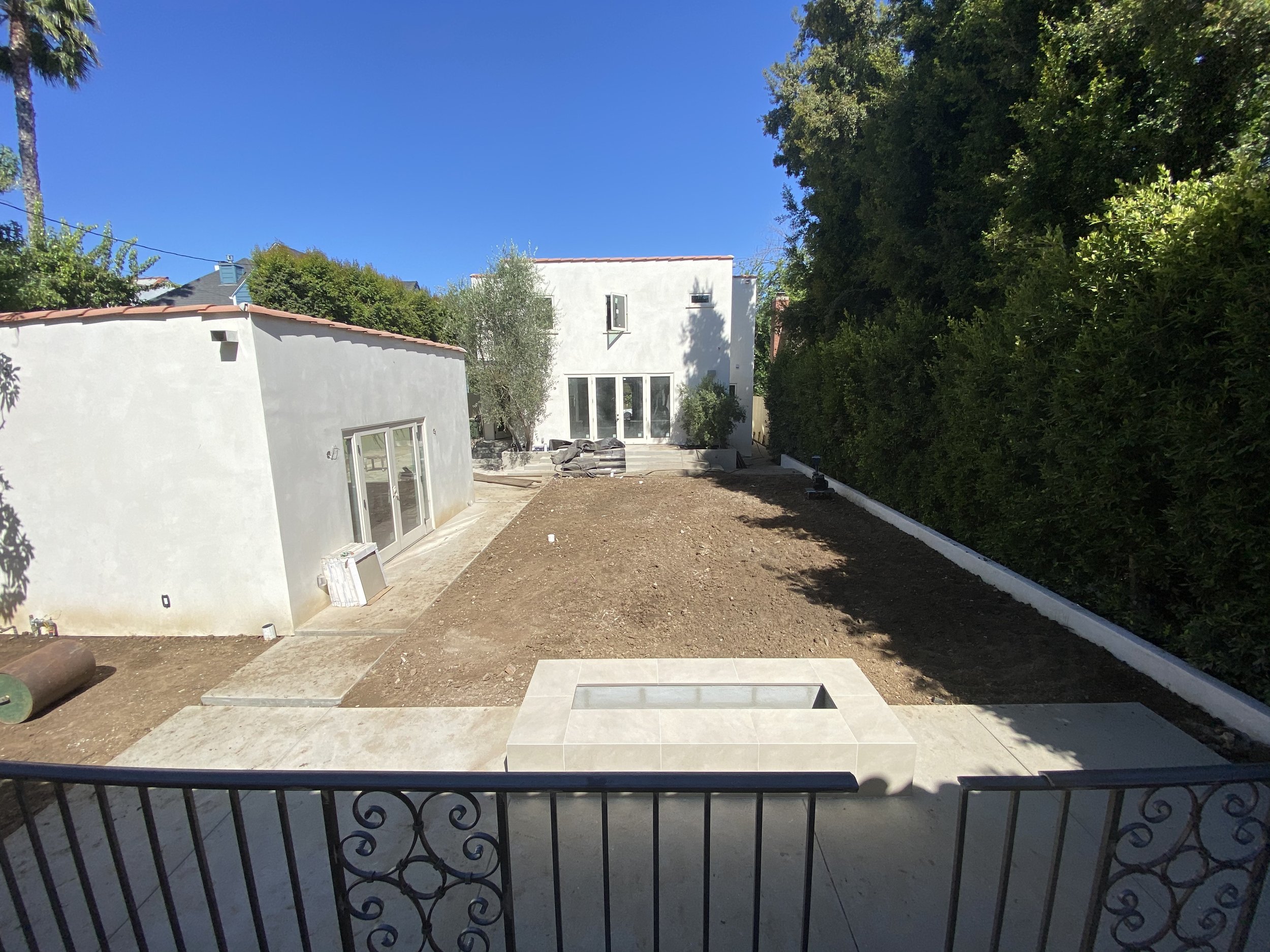 Hancock Park home renovation in progress showing backyard grading, ADU structure, and early outdoor layout integration