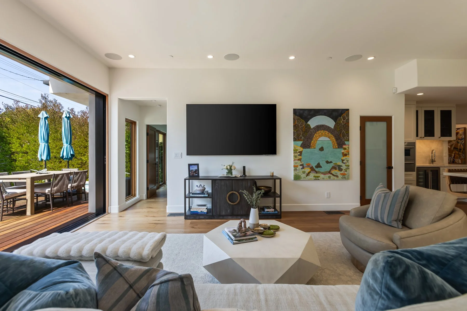 Modern living room renovation in Westwood with large sliding doors and open concept layout