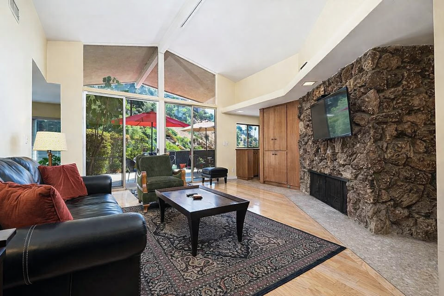 Hollywood Hills kitchen before remodel with closed layout, original wood cabinetry, limited counter space, and minimal connection to adjacent living areas