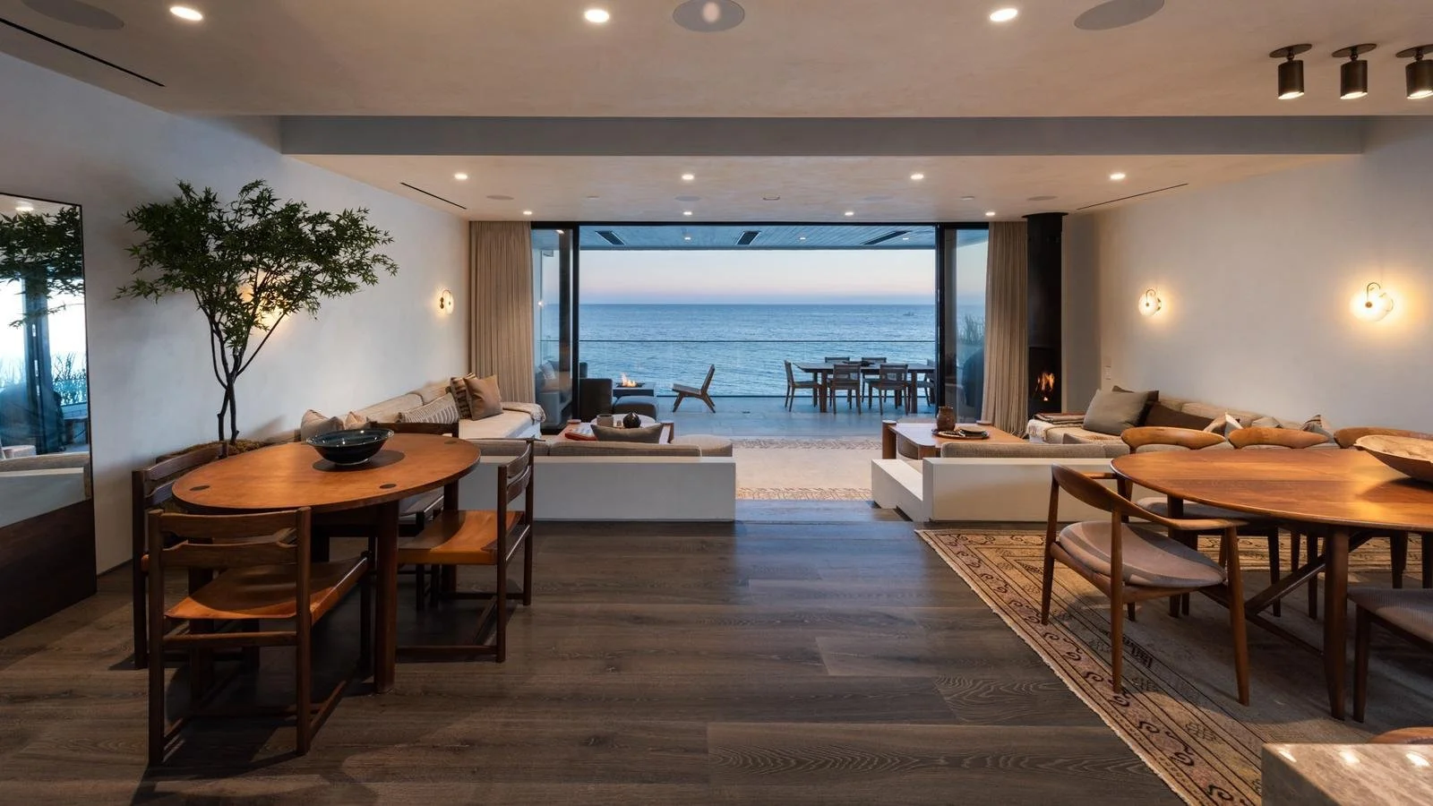 Oceanfront Malibu Pier condo living room with retractable glass walls and seamless indoor-outdoor terrace overlooking the Pacific Ocean