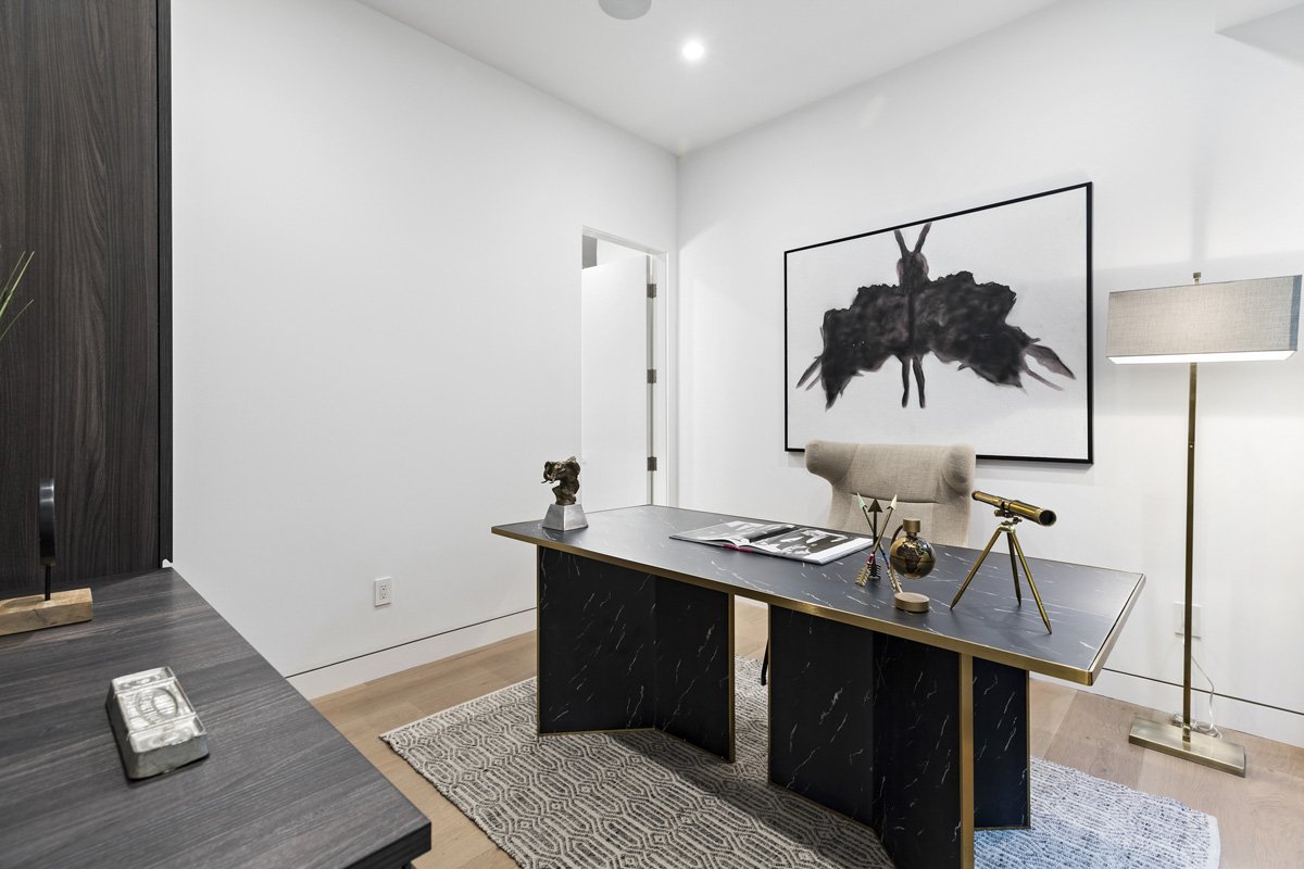 Beverly Hills private office with marble desk, abstract wall art, and modern floor lamp