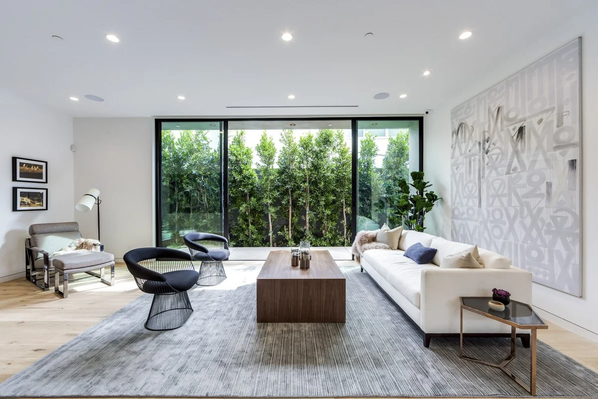 West Hollywood custom home living room with floor-to-ceiling glass doors and garden-facing lounge seating