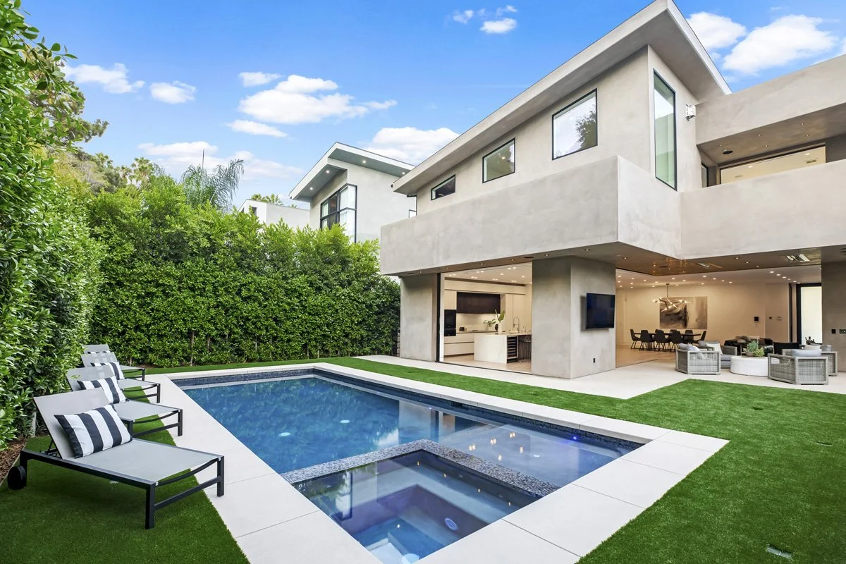 Beverly Hills custom home backyard with modern pool, spa, turf lawn, and open indoor-outdoor living