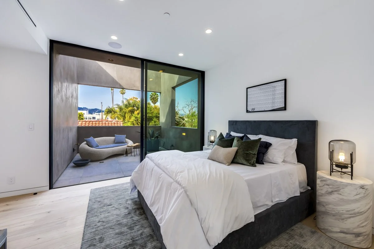 West Hollywood custom home primary bedroom with private balcony and expansive city views
