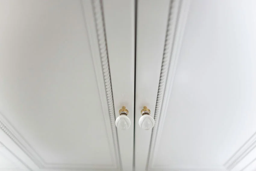 Custom white cabinetry with bead detail and brass hardware in Hancock Park bathroom vanity