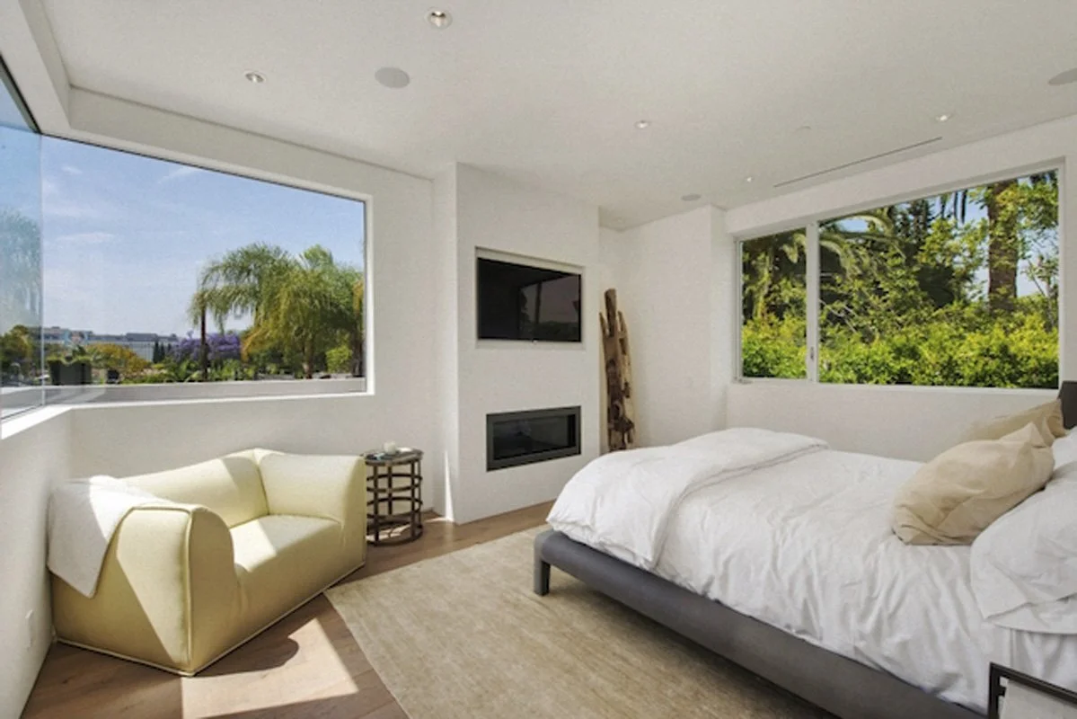 Bedroom with city views and fireplace in West Hollywood contemporary custom home.