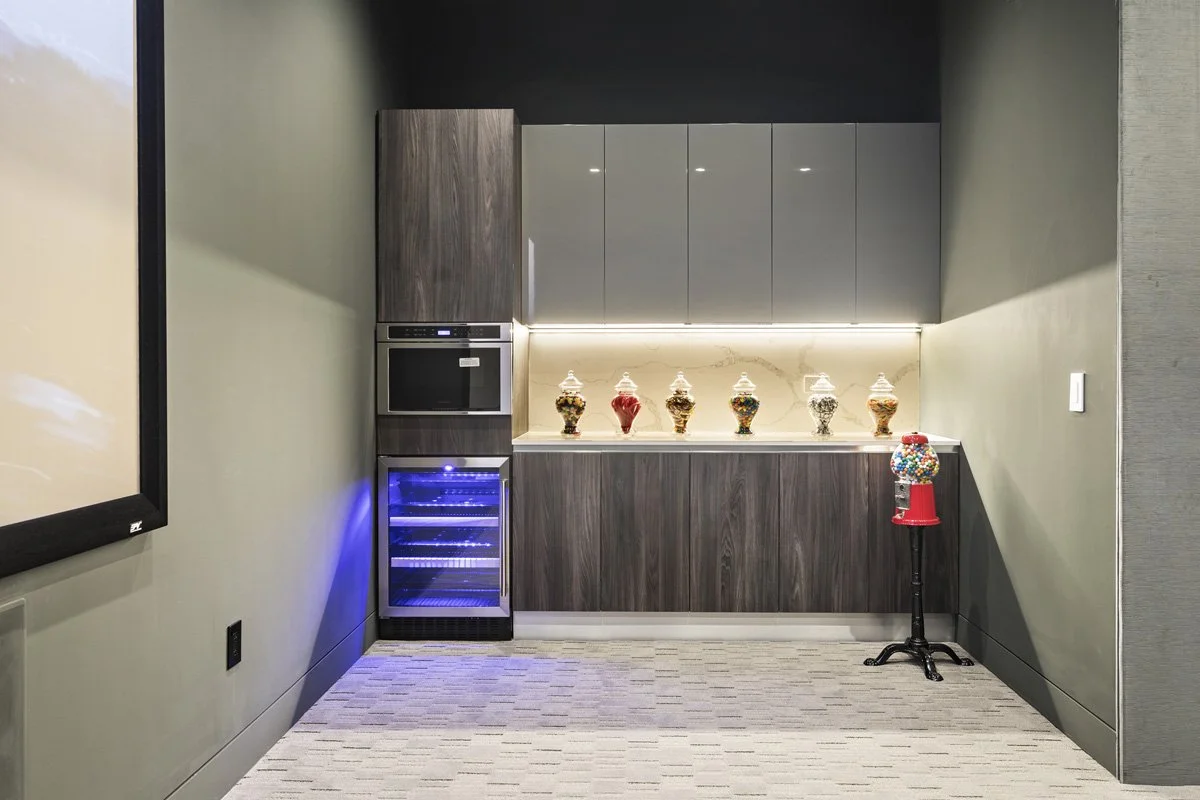 Beverly Hills custom bar area with walnut cabinetry, integrated wine refrigerator, and quartz backsplash