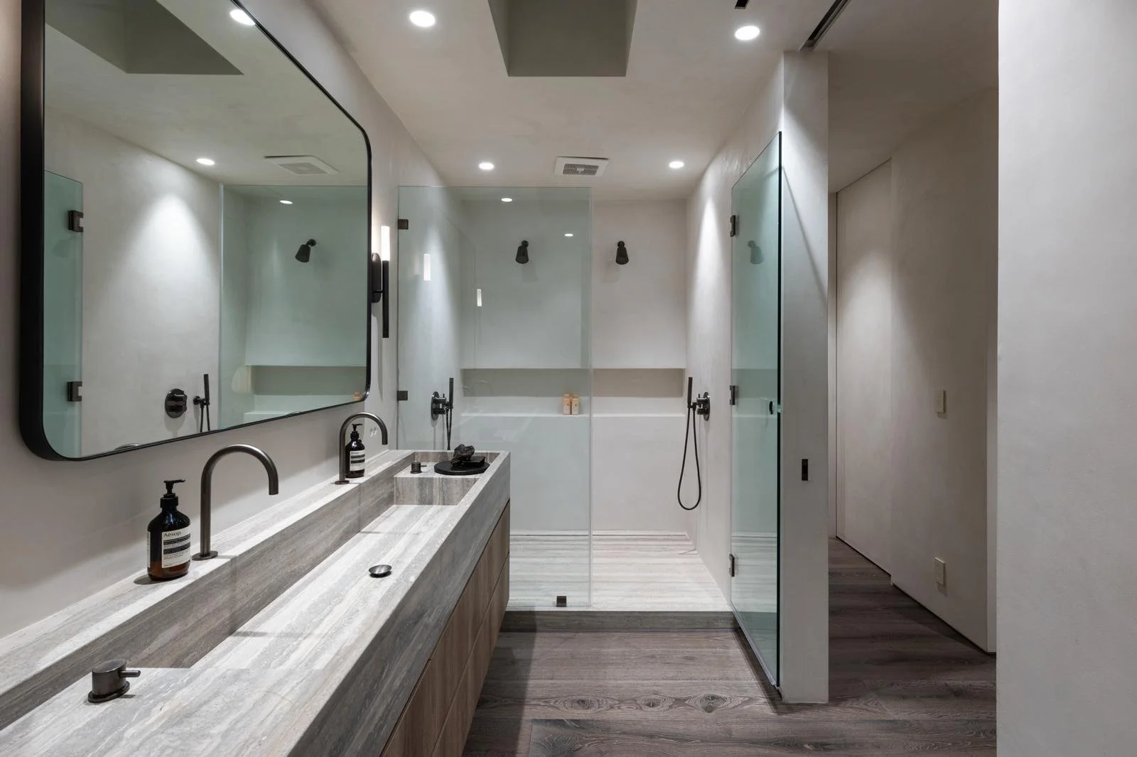 Malibu condo bathroom remodel with modern walk-in shower, double vanity, and clean minimalist finishes