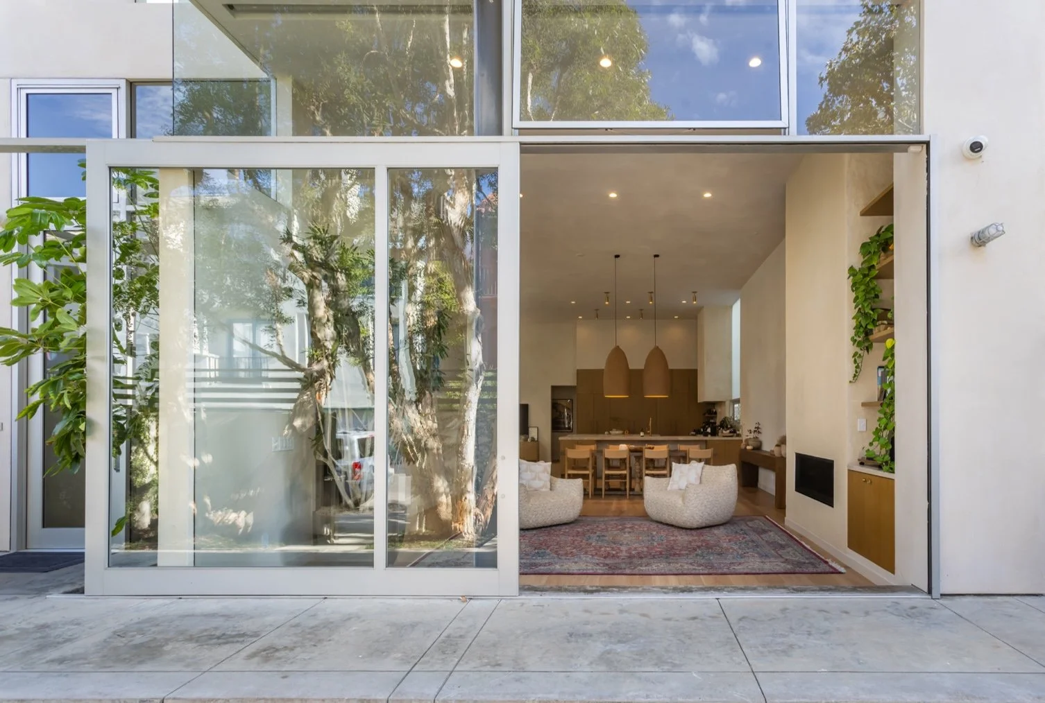 Modern urban coastal home in Los Angeles with large sliding glass doors opening to an open-concept living space, designed for indoor-outdoor living near the coast.