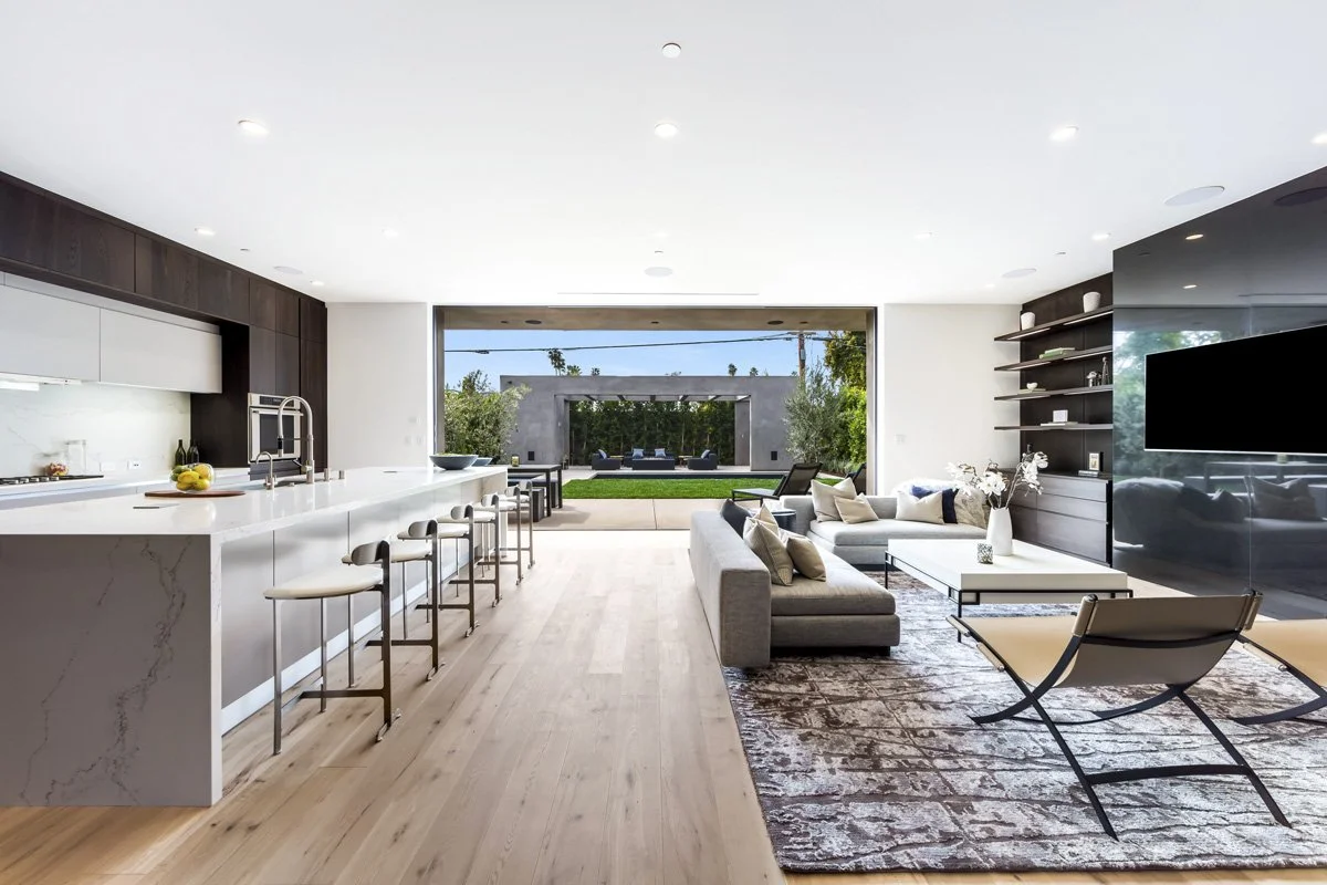 Open-concept West Hollywood living room and kitchen with wide-plank oak floors and seamless indoor-outdoor connection