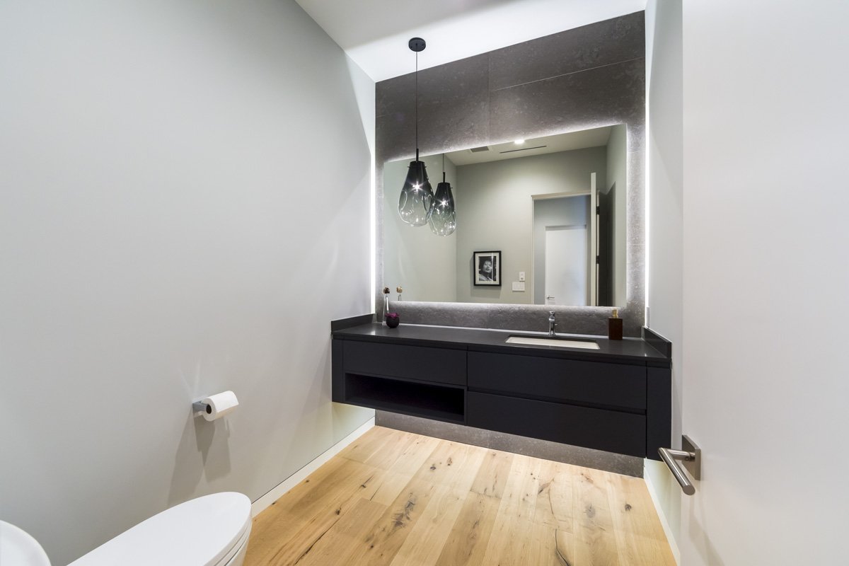 West Hollywood custom home powder room with floating vanity and backlit mirror