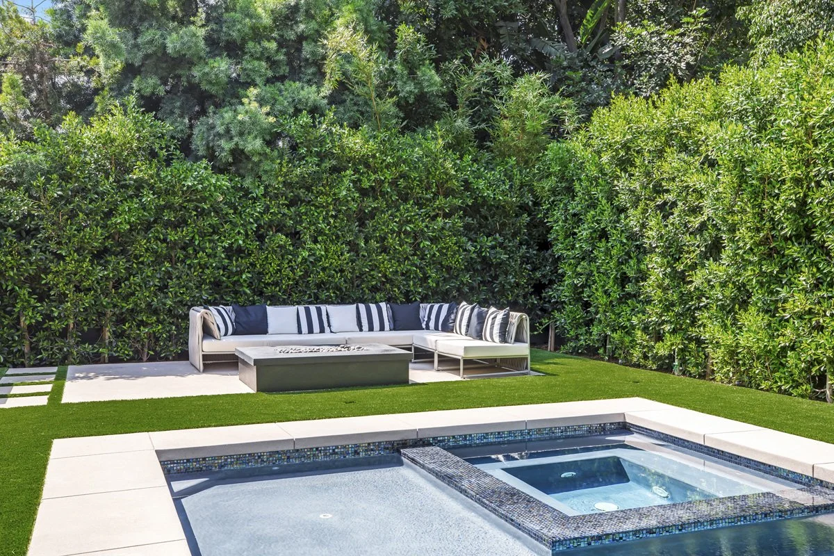 Beverly Hills custom spa and outdoor sectional seating area with fire table and turf lawn