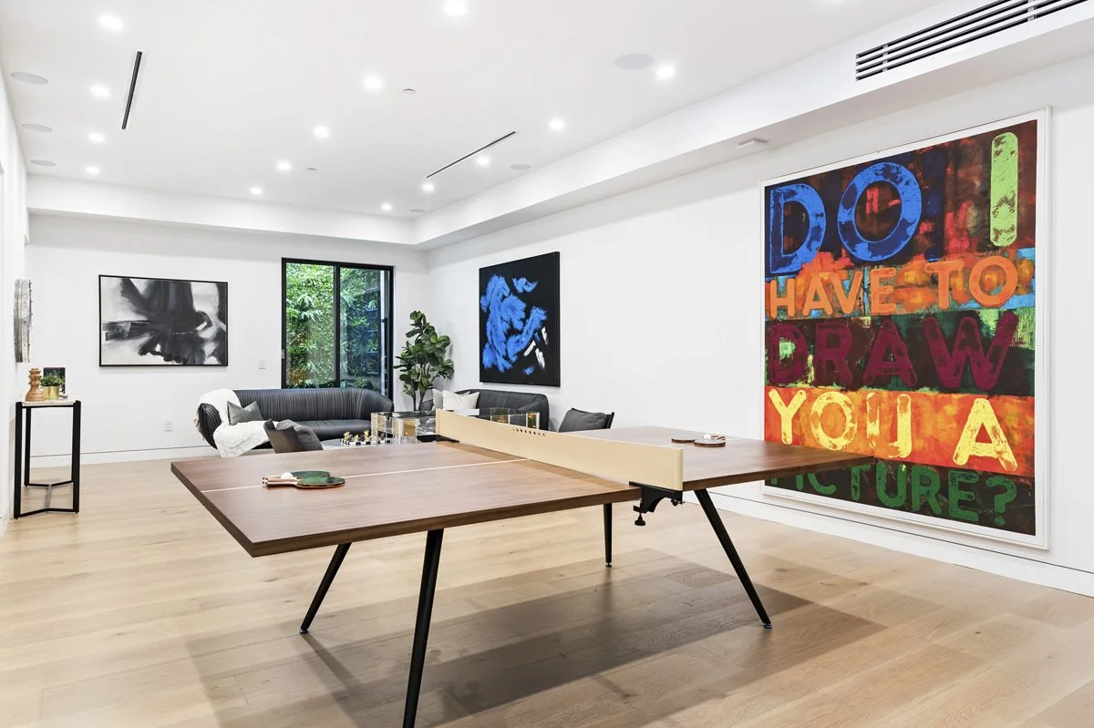 Beverly Hills lower-level entertainment room with custom ping pong table and large-scale contemporary artwork