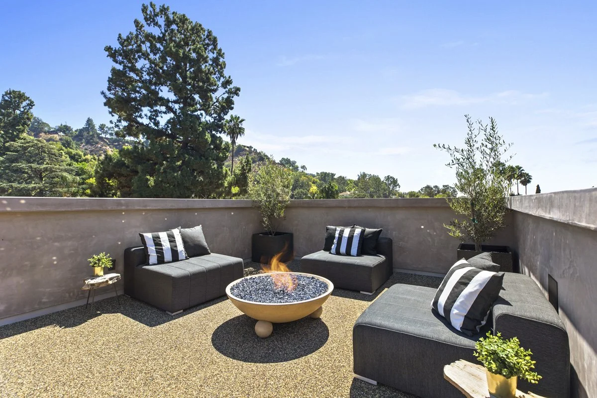 Beverly Hills rooftop fire pit seating area with modern outdoor furniture and stucco privacy walls
