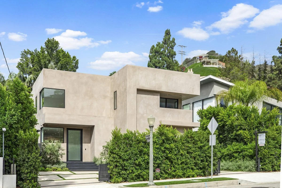 Beverly Hills custom home exterior with smooth plaster façade, layered landscaping, and modern geometric architecture