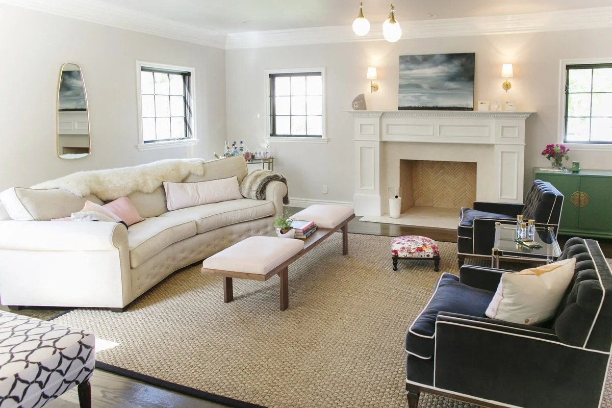 Bright Hancock Park living room with fireplace mantel, neutral sofa, velvet lounge chairs, and woven area rug