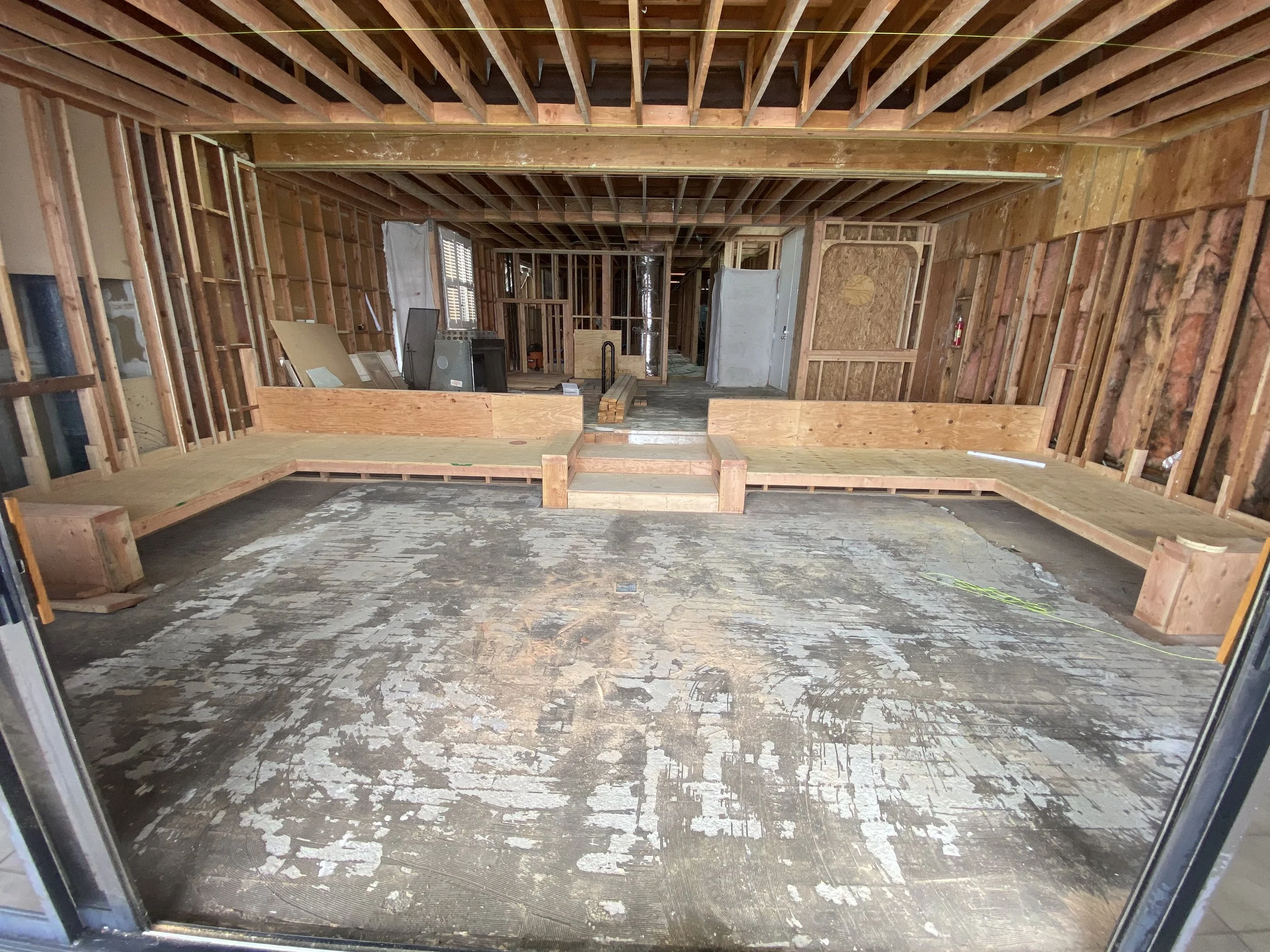 Malibu condo remodel in progress with new platform framing, exposed structure, and reconfigured layout during full rebuild phase