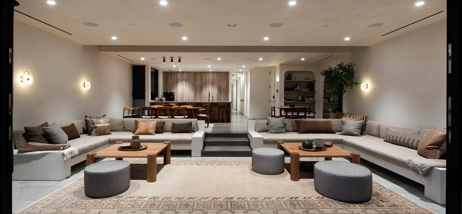 Malibu condo remodel completed showing open-concept living area with reconfigured layout, recessed lighting, and connected family spaces