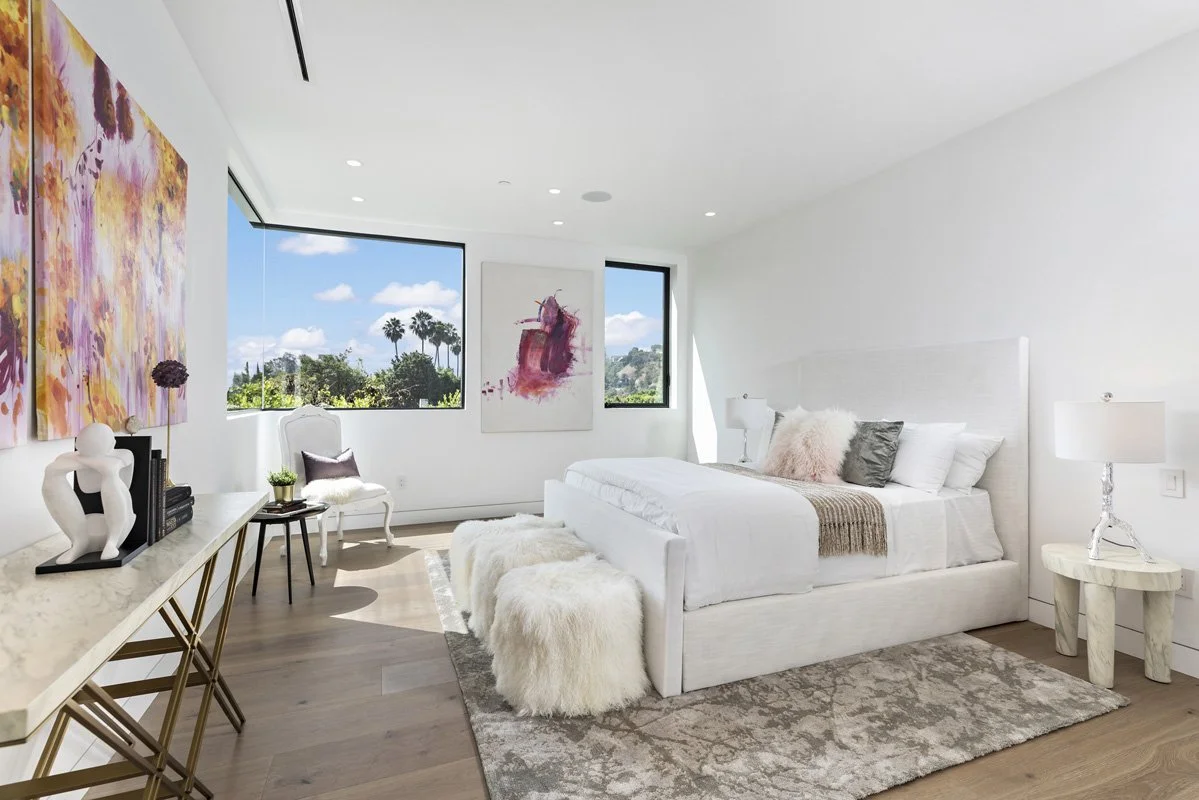 Beverly Hills modern bedroom with upholstered bed frame, marble side table, and panoramic windows