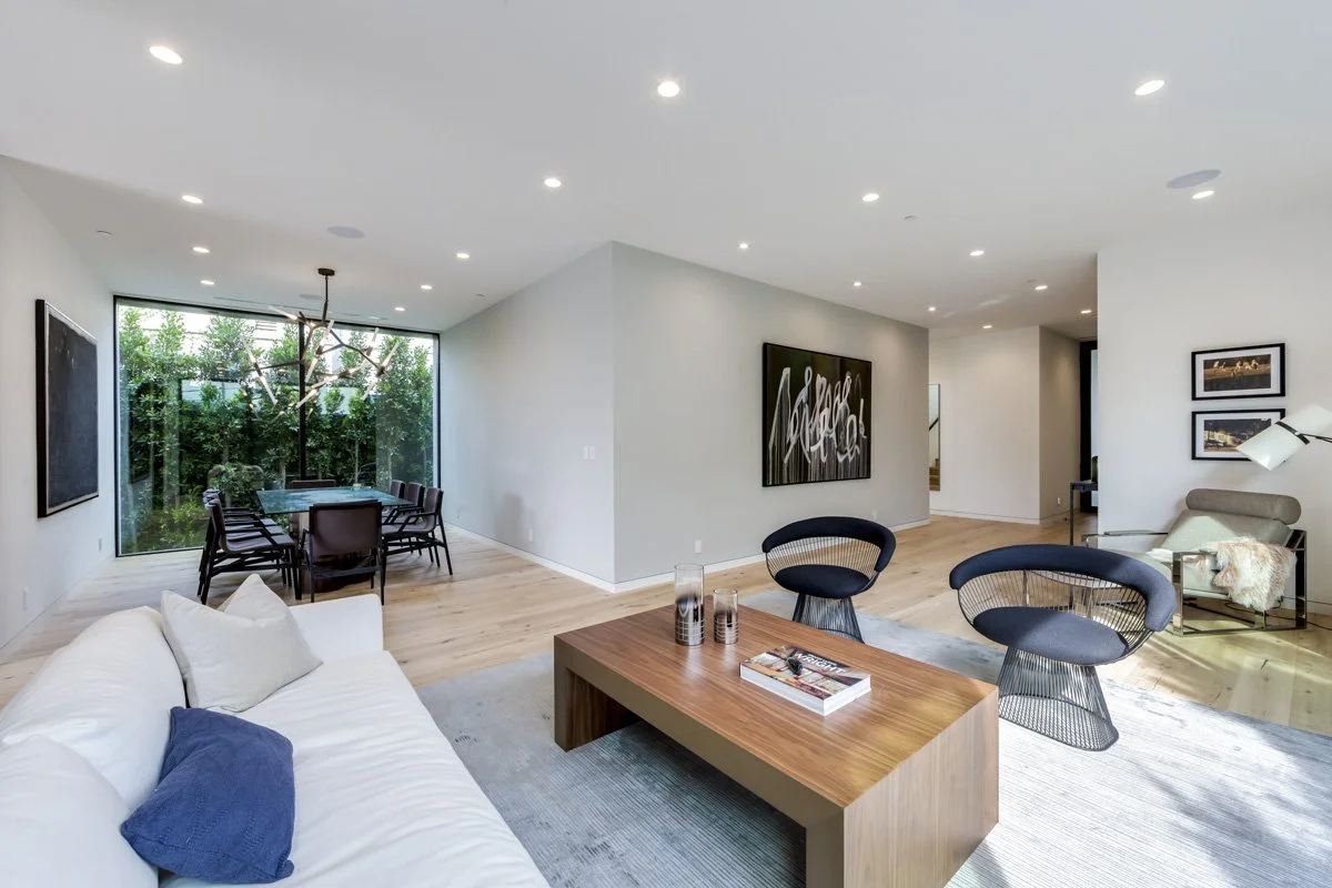 West Hollywood custom home open-plan living and dining area with floor-to-ceiling garden-facing windows