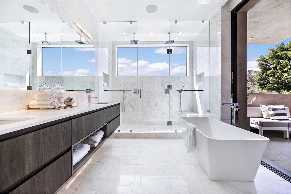 Luxury Beverly Hills bathroom remodel with marble finishes, frameless glass shower, and freestanding soaking tub.