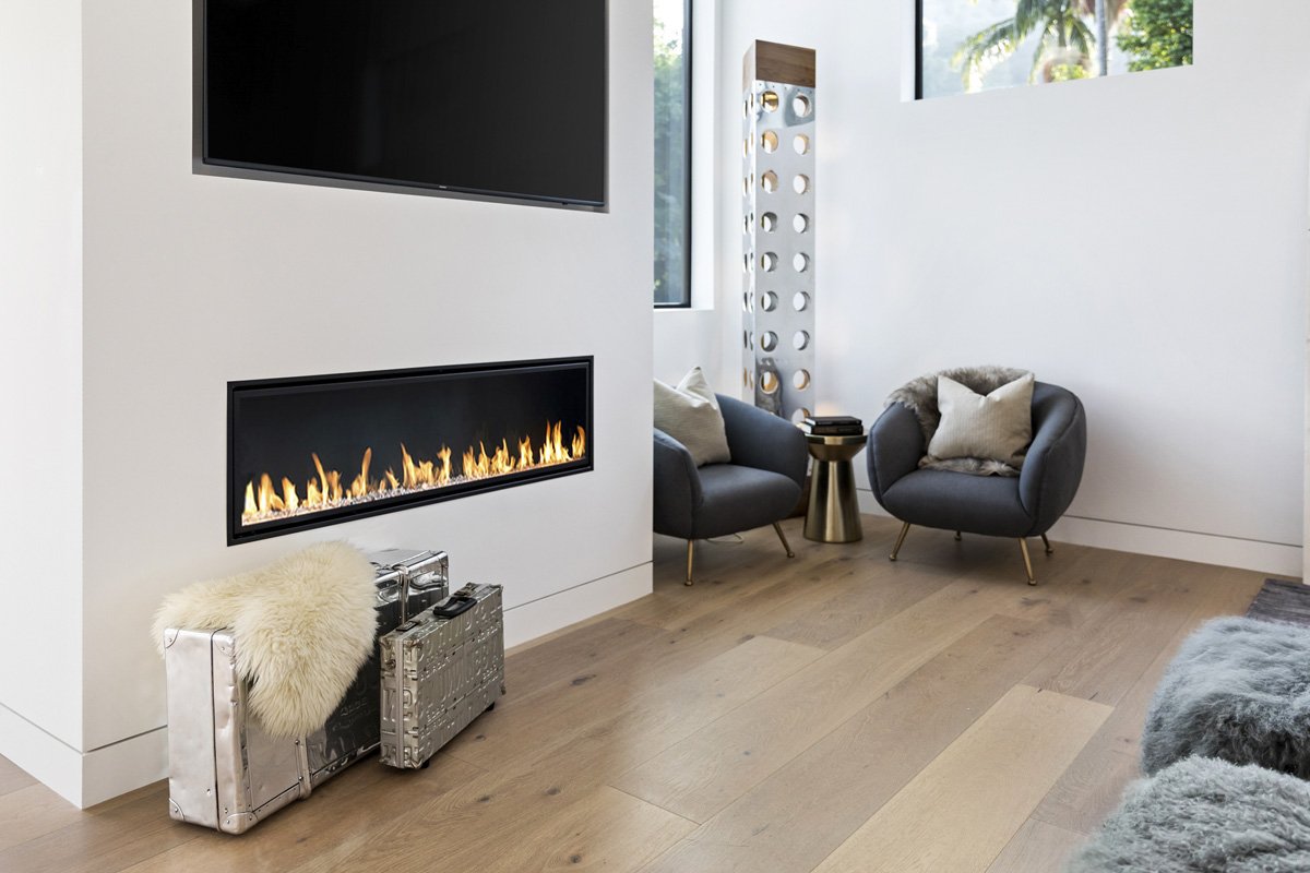Beverly Hills bedroom seating area with contemporary lounge chairs and built-in fireplace detail