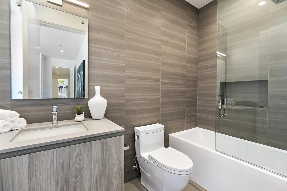 Beverly Hills secondary bathroom with wood vanity, quartz countertop, and tiled tub-shower combination