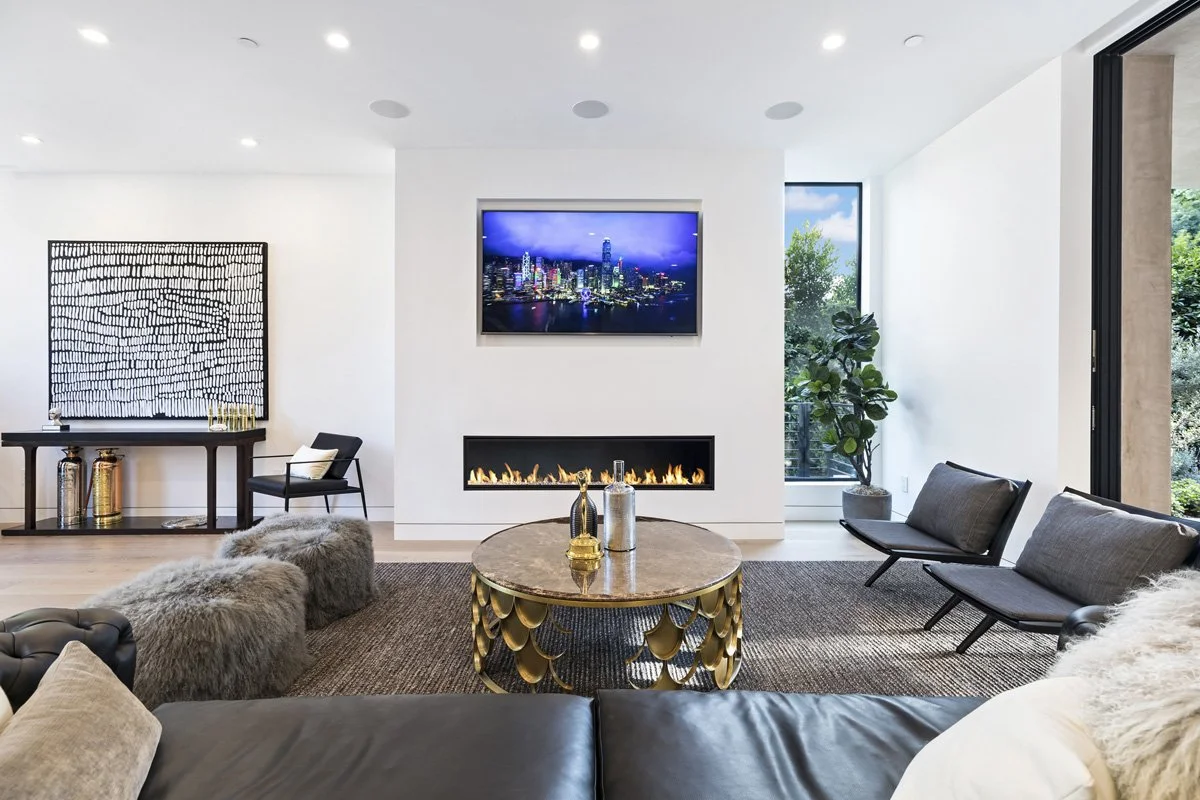Beverly Hills modern living area with fireplace, oak flooring, and contemporary lounge seating