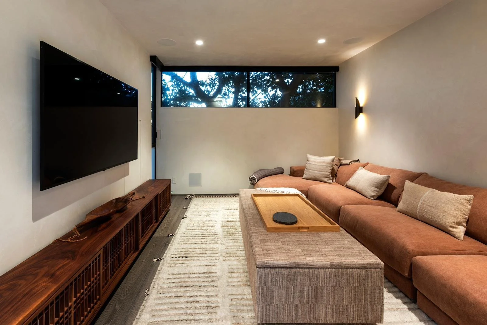 Malibu home media room with sectional seating and wall-mounted television.