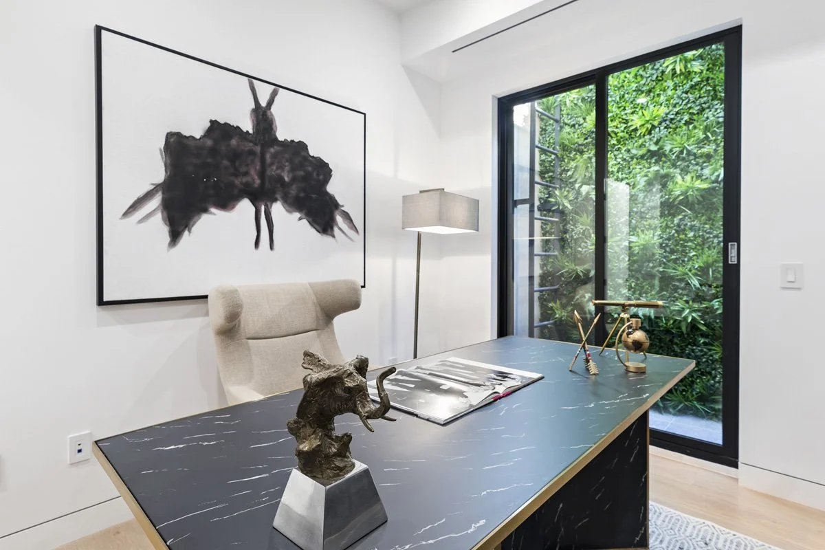 Beverly Hills modern home office with garden-facing glass door and sculptural decor details