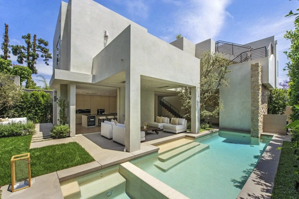 Modern backyard with lawn, pool, and covered outdoor lounge in West Hollywood custom home.