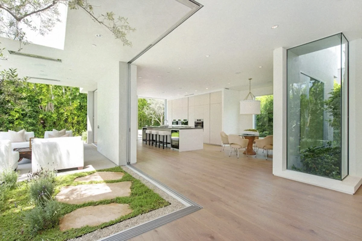 Courtyard garden with stepping stones and sliding glass doors in West Hollywood modern residence.