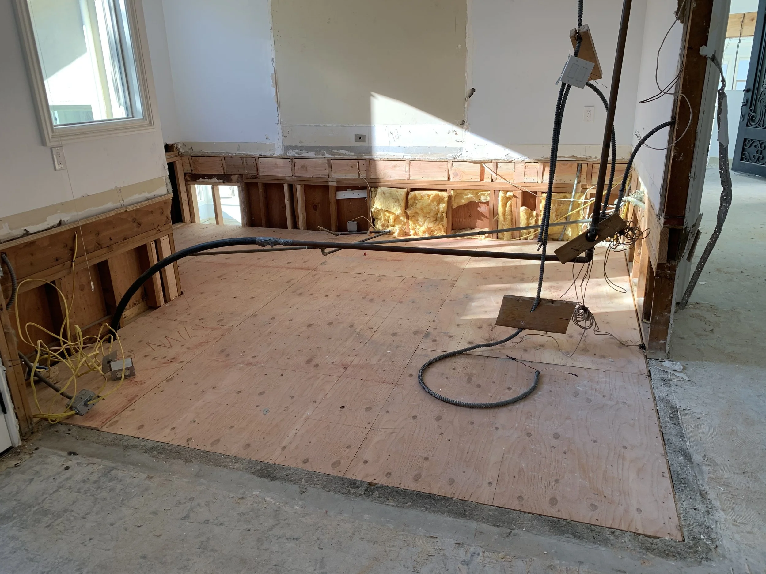During remodel installation of new subfloor and rough electrical and plumbing in open layout reconfiguration