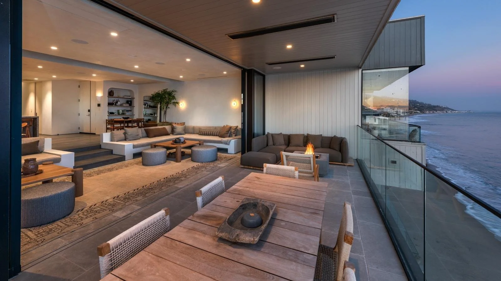 Malibu condo after remodel with indoor-outdoor living space, open layout, and seamless connection to ocean-facing terrace