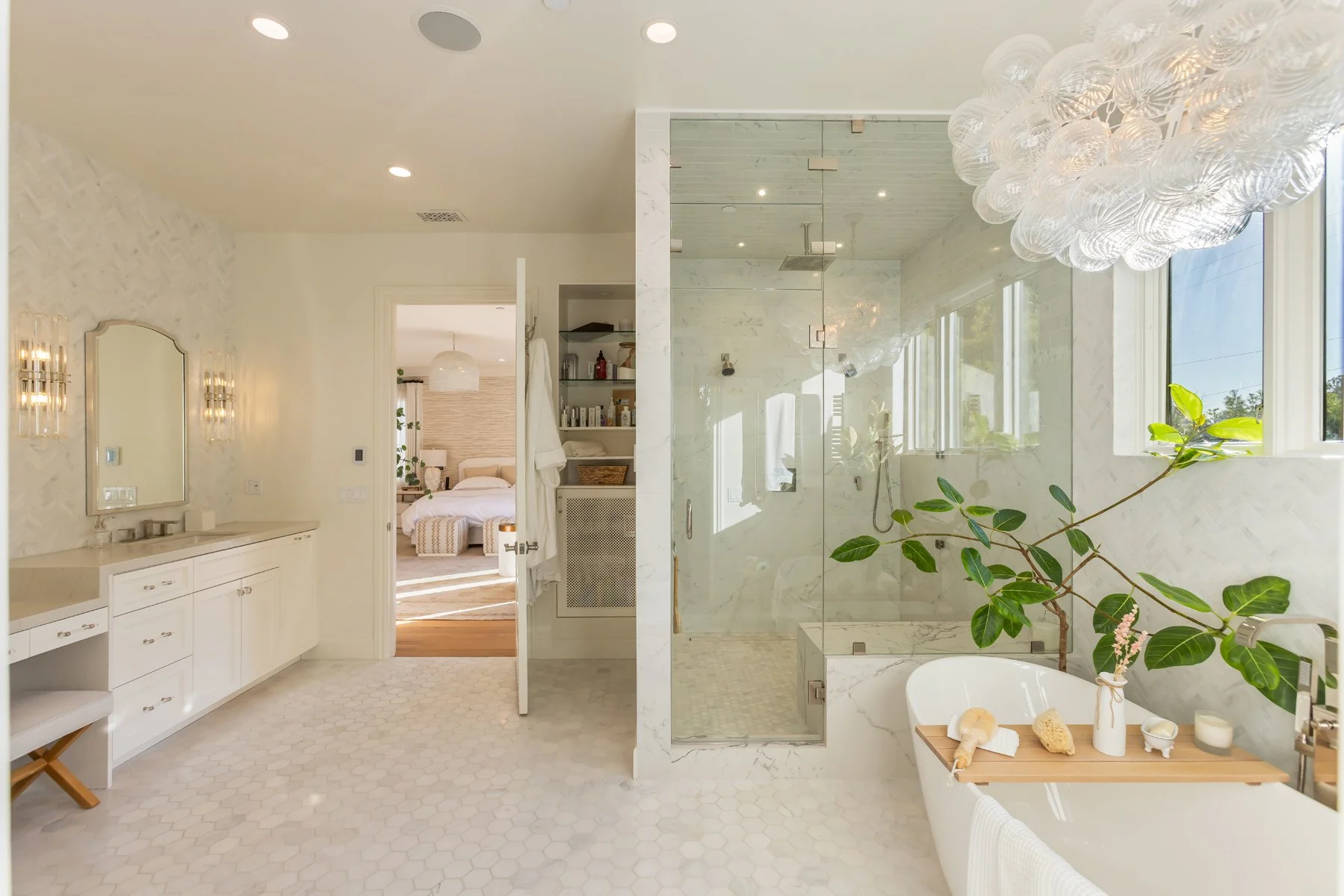 Primary bathroom in a custom Brentwood home featuring a freestanding soaking tub, glass-enclosed walk-in shower, dual vanity, and soft natural light.